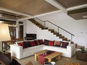 a living room with a white couch with red pillows at Veranda High Resort Chiang Mai - MGallery Collection, Accor Hotel in Hang Dong +111 photos