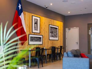 a living room with a table and chairs and a flag at ibis Valparaiso in Valparaíso