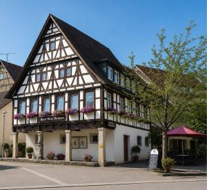 a building with flower boxes on the front of it at Hotel Altes Rathaus in Ostfildern