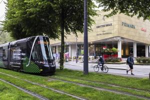 a bus on a street in front of a building at Superbe Appartement ! in Saint-Étienne