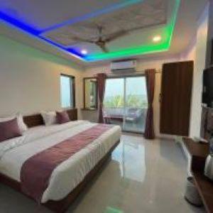 a bedroom with a bed with a blue ceiling at Hotel Green lotus villa mahabaleshwar in Mahabaleshwar