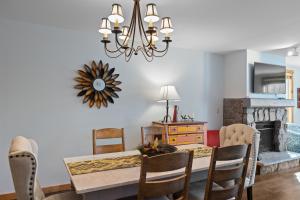 a dining room with a table and a chandelier at Buffalo Lodge #8392 in Keystone
