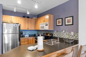 a kitchen with wooden cabinets and a stainless steel refrigerator at Buffalo Lodge #8392 in Keystone