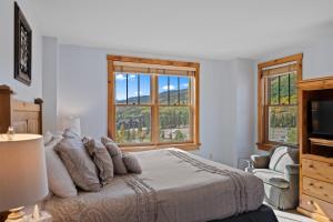 a bedroom with a bed and a large window at Buffalo Lodge #8392 in Keystone