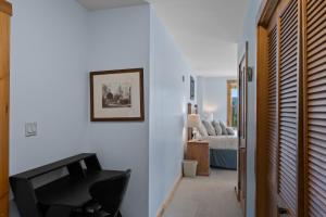 a living room with a black chair and a bed at Buffalo Lodge #8392 in Keystone +15 photos