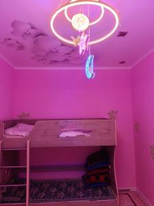 a room with a purple ceiling with a bed in it at Sherine house in Tamga