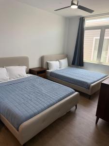 a bedroom with two beds and a ceiling fan at Coral Sands in Seaside Heights