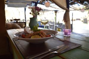 a bowl of food on a table with a plate of food at Hotel Observatorio TukunMapu in Vicuña