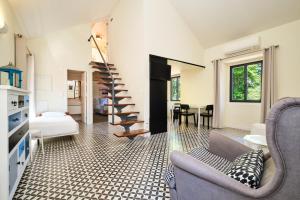 a living room with a spiral staircase and a bedroom at Sintra Bliss A Part in Sintra