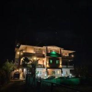 a building with a green light in front of it at Hotel Green lotus villa mahabaleshwar in Mahabaleshwar