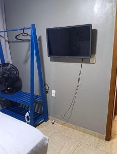 a room with a tv on the corner of a wall at Verde Mar Abricó 4 in Rio das Ostras