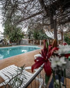 a patio with a table and a swimming pool at Hotel Observatorio TukunMapu in Vicuña