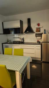 a kitchen with a table and two chairs and a stove at Apartman i Studio apartman Majoli in Kukuljanovo