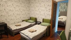 a room with two beds and chairs in it at Apartman i Studio apartman Majoli in Kukuljanovo