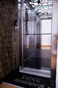 an elevator in a building with a sign on the floor at Dine Residence in Himare
