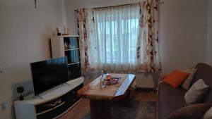 a living room with a television and a coffee table at Zgona in Livno