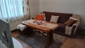 a living room with a couch and a wooden table at Zgona in Livno