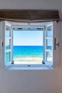 an open window with a view of the ocean at Esperanza Home Mandrakia in Mandrakia