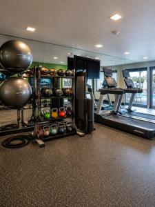 a room with a gym with a treadmill and balls at Spark by Hilton Tempe Phoenix Airport in Tempe