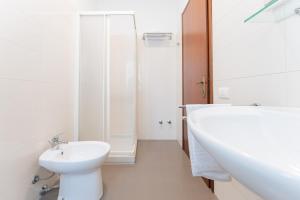 a white bathroom with a sink and a toilet at Affittacamere Pizzeria Ristorante Treppì in Caldiero