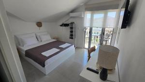 a bedroom with a bed and a desk with a chair at Vele House Walk to Beach in Herceg-Novi