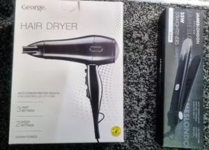 a hair dryer in a box next to a book at RA7C Stylish Loft Stay in Batley