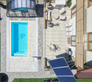 an overhead view of a pool with a blue door at ApartPodhale in Raba Wyżna