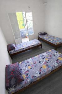 a room with three beds with flowers on it at F3 SALAMANDRE à CORNICHE CASA MAZA in Mostaganem