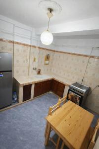 an empty kitchen with a table and a stove at F3 SALAMANDRE à CORNICHE CASA MAZA in Mostaganem