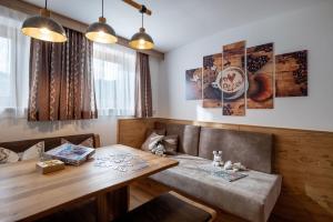 a dining room with a wooden table and chairs at Ferienwohnungen Luxner in Gerlos