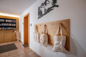 a room with three bags hanging on a wall at Ferienwohnungen Luxner in Gerlos