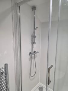 a shower in a bathroom with a shower at Charming Wootton in Hail Weston +18 photos