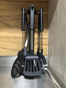 a group of kitchen utensils hanging from a wall at Habita Coliving La Palma in Medellín