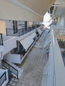 a row of white benches in a building at Gatos Beach in Pefkochori
