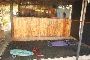 a out house with a skateboard and a red leash at Mojo Surf House in Popoyo +1 photo