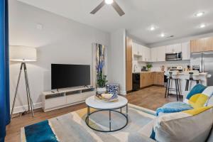 a living room with a couch and a table at Spacious 2BR N Gulch Walk to Broadway & Rooftops in Nashville