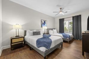 a bedroom with two beds and a ceiling fan at Spacious 2BR N Gulch Walk to Broadway & Rooftops in Nashville