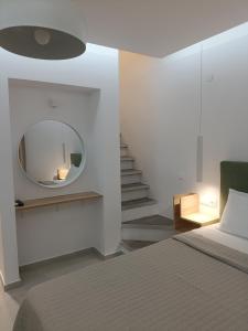 a bedroom with a bed and a mirror on the wall at Gatos Beach in Pefkochori