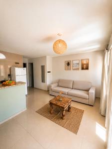 a living room with a couch and a table at Condomínio Harmonia in Pipa