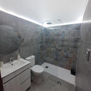 a bathroom with a toilet and a sink and a shower at Campo Dias in Silves +35 photos