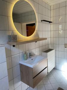 a bathroom with a sink and a mirror at Casa Piedra in Kleinsteinhausen