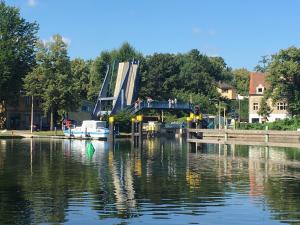 a bridge over a body of water with people on it at Ferienwohnung Bandow in Woltersdorf +11 photos
