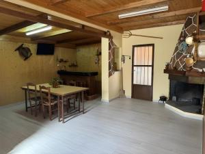 a room with a table and chairs and a fireplace at Casa Bartolo in Vélez-Rubio