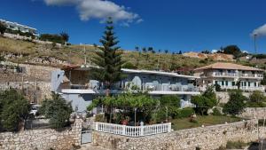 a large house with a tree in front of it at Escape Rooms in Himare