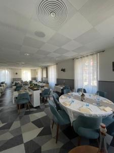 a dining room with tables and chairs and a ceiling at Auberge de la Charrue in Romanel-sur-Lausanne