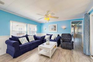 a living room with a couch and a ceiling fan at Oyster Lane Hideout in Ocean City