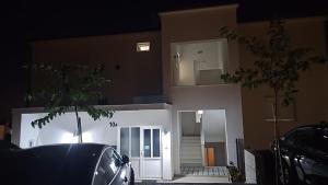 a car parked in front of a house at night at DaVita in Novalja