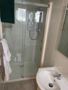 a bathroom with a shower and a sink at Minch View Cabin 2, 1 Earlish in Earlish