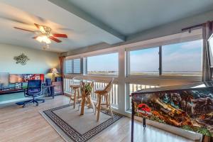 a living room with a desk and a fish tank at Our Place At The Beach 206B in Ocean City