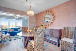 a living room with a blue couch and a table and chairs at Boho Bayshore 42 in Ocean City
